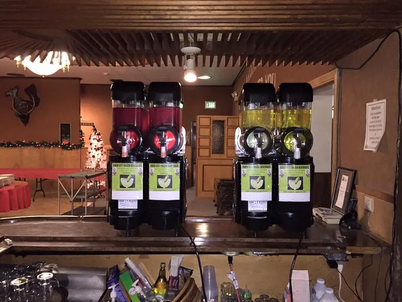 Two margarita machines on a bar at a party