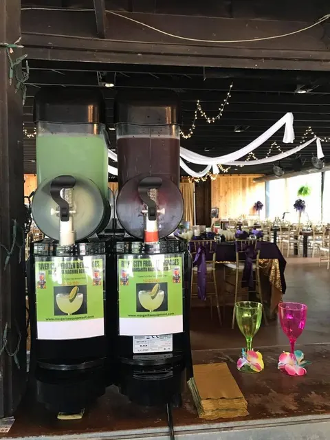 Margarita machine at an evening reception with string lights
