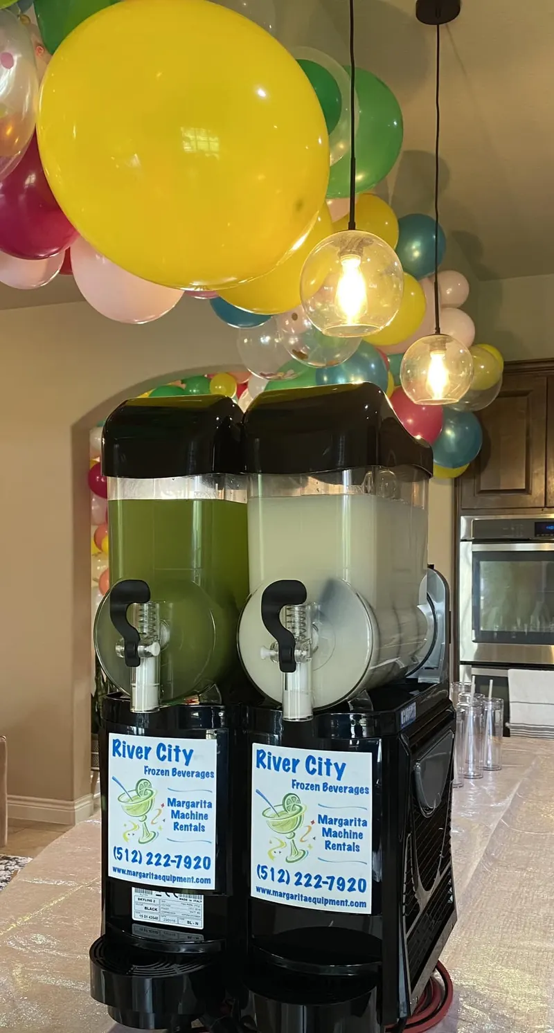 Two-flavor margarita machine set up for a party with balloons